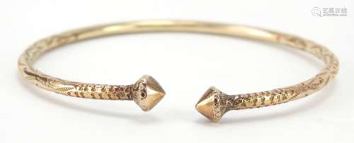 Unmarked gold bangle, (tests as 9ct gold) engraved with flowers, 7cm wide, 22.2g : For Further