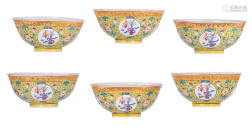 Six Chinese yellow ground famille rose floral decorated bowls, the panels with flower vases, the ins