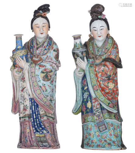 Two exceptional Chinese polychrome decorated figures, depicting a lady, each holding a vase, their r