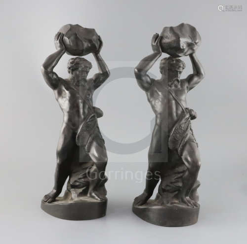 Two Russian bronzed cast iron figures of Hercules, standing holding a large rock with ram's skin