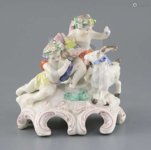 A Vauxhall porcelain group of two Bacch****ian cherubs and a goat, c.1760-5, on a scrollwork base,