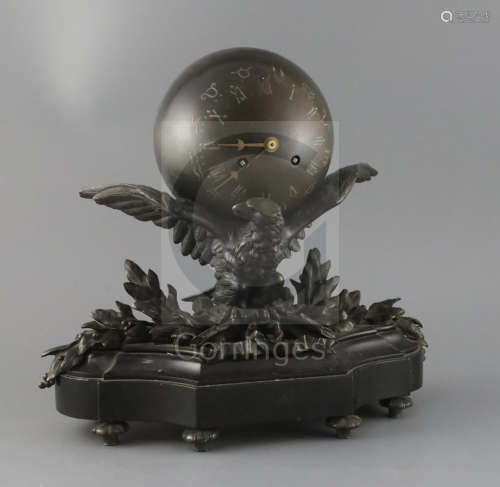 A late 19th century French bronze mantel clock modelled as a globe supported by an eagle, the