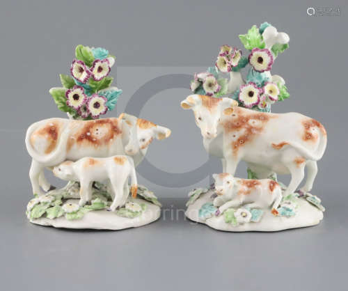 A near pair of Derby groups of a cow and calf, c.1760-5, on flower encrusted bases, patch marks,