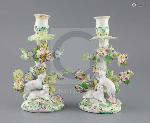 A pair of early Derby 'sheep' candlesticks, c.1758, each modelled with two sheep below a flower