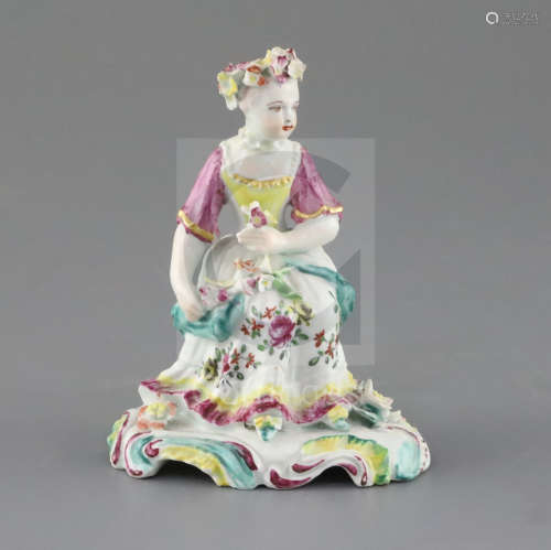 A Derby 'pale family' figure of a seated lady, c.1756-8, holding flowers in her hands on a