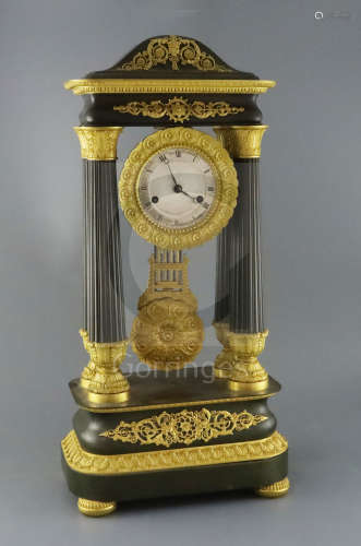 A mid 19th century French bronze and ormolu portico clock, of ornate architectural form, decorated