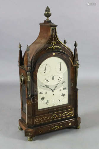 A large Regency brass inset maho***y repeating chiming bracket clock, with swept arched case,
