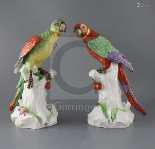 A pair of large German porcelain models of parrots, late 19th century, with glass inset eyes, each