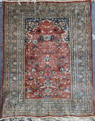 A Tabriz silk rug, on a russet ground, with multi row border, 5ft 9in by 4ft 6in.