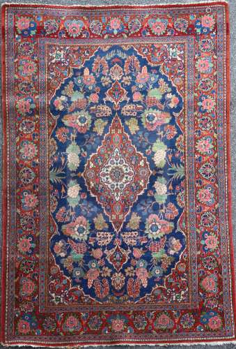 A Kashan blue ground rug, with foliate field and multi row border, 6ft 8in by 4ft 5in.