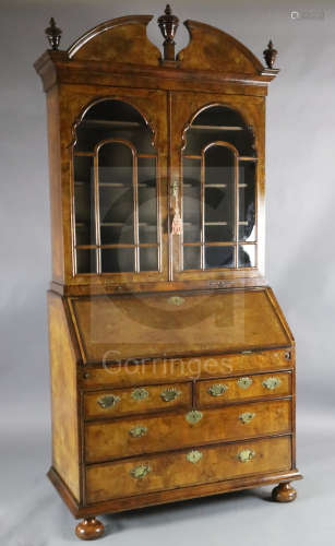An 17th/18th century walnut bureau bookcase, with broken arch cornice and two astragal glazed