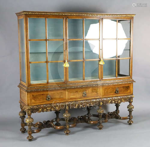 A 1930's Queen Anne revival walnut display cabinet, with two barred glazed doors flanking a