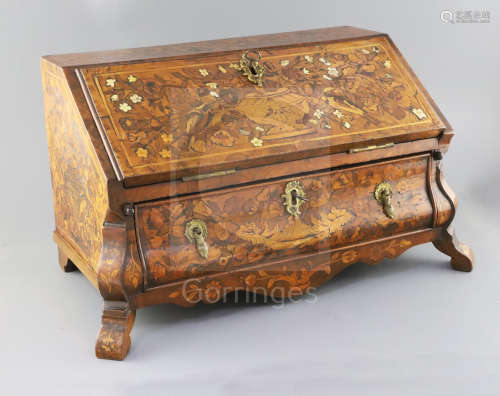 A late 18th century Dutch walnut and marquetry table top bureau, the fall enclosing a pigeon hole