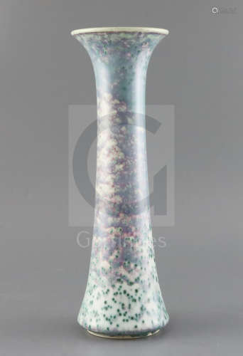 A tall Ruskin high fired vase, dated 1925, decorated with a lilac, lavender, a green speckled glaze,