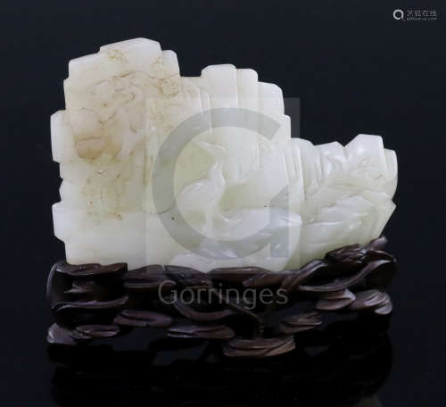A Chinese pale celadon jade landscape carving, 19th century, carved in high relief with rocks,