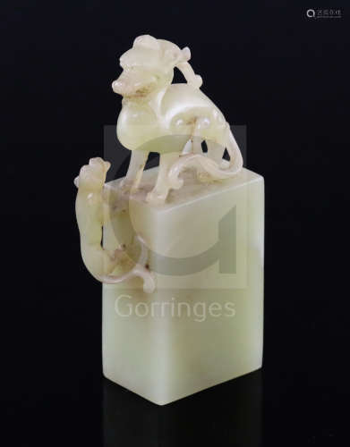 A Chinese greenish-yellow jade seal, 19th/20th century, carved within openwork with a lion-dog and