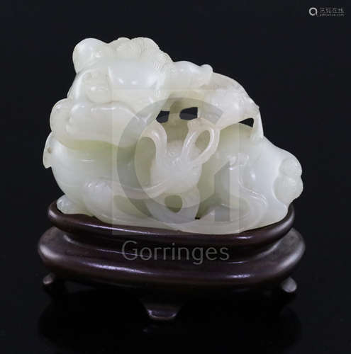 A Chinese pale celadon jade figure of a lion dog and cub, 18th/19th century, the stone of good