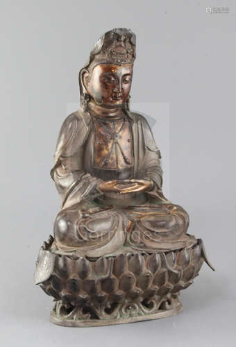 A large Chinese lacquered bronze seated figure of Guanyin, on a separate lotus stand, her robes