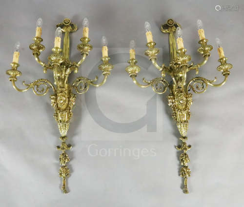 A pair of late Victorian ornate cast brass five branch wall lights, modelled with ribbon stems,