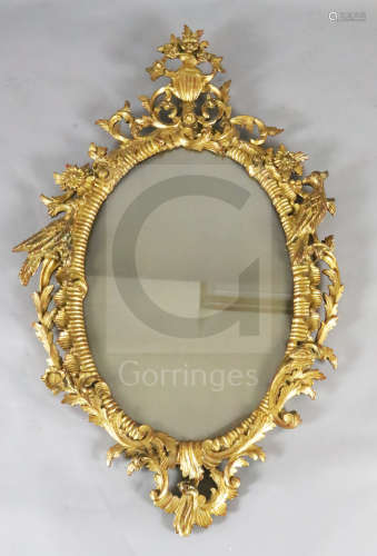 A George III carved giltwood wall ***ror, with flowers in a ewer crest and ho-ho birds to each