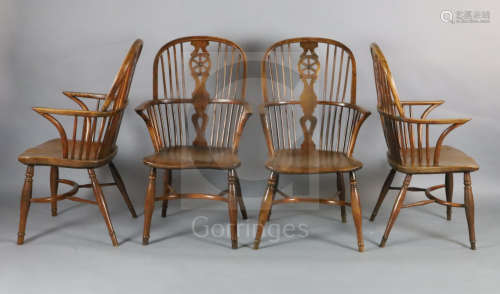 A near set of four 19th century yew, ash and elm Windsor chairs, with wheel backs, saddle seats