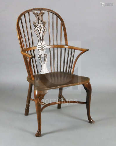 An early 19th century yew, ash and elm Windsor chair, with ornate carved and pierced splat,