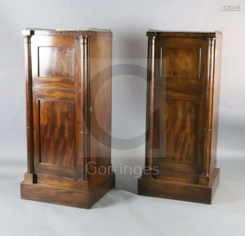 A pair of Regency maho***y inverse breakfront pillar cabinets, with brass three quarter galleries