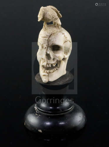 A 19th century Dieppe carved bone memento mori, with a bird perched upon a part fleshed skull, on