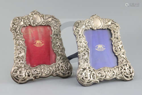 A pair of Edwardian repousse silver mounted photograph frames, by Goldsmiths & Silversmiths Co