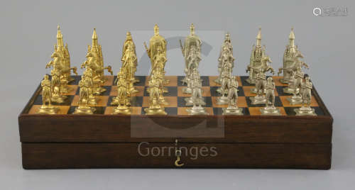 A figural silvered and gilded metal chess set in fitted rosewood and boxwood folding box/chess