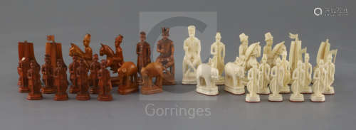 A rare 18th century white and brown walrus ivory Russian chess set, featuring Russians against