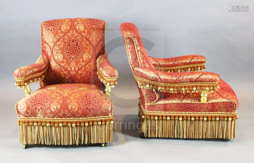 A set of four Victorian giltwood armchairs, ornately upholstered in tasselled gold and red foliate