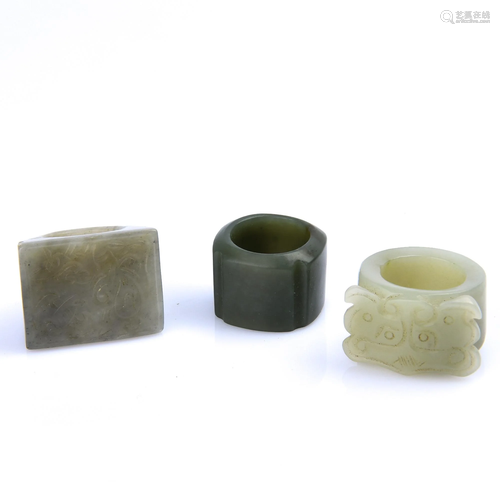 THREE CARVED JADE ARCHER'S RINGS