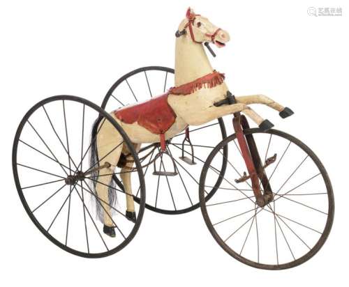 A wooden polychrome painted tricycle toy horse, th…