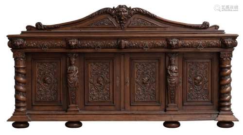 An imposing and large oak sideboard, the four door…