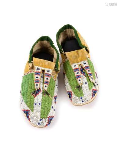 A pair of Arapaho moccasins. Plains. Buckskin with…