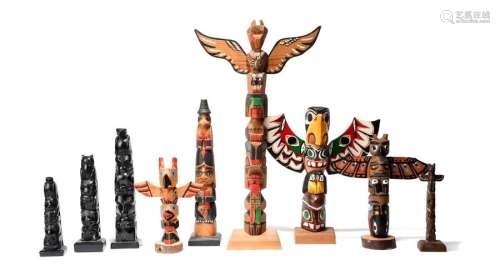 Nine model totem poles. Five carved cedar or pine …