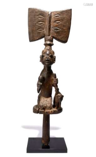 A Yoruba Shango wand. Nigeria. The kneeling figure…
