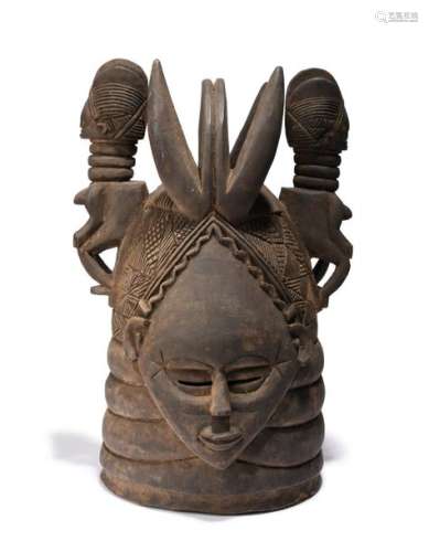 A Mende helmet mask. Sierra Leone. With a ringed n…
