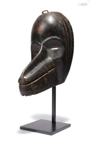 A Dan mask. Ivory Coast. With linear scarification…