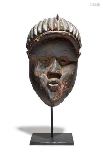 A Bassa mask. Liberia. 21cm high, on a stand. (2).…