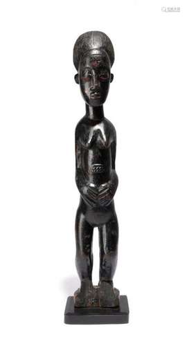 A Baule standing female figure. Ivory Coast. With …