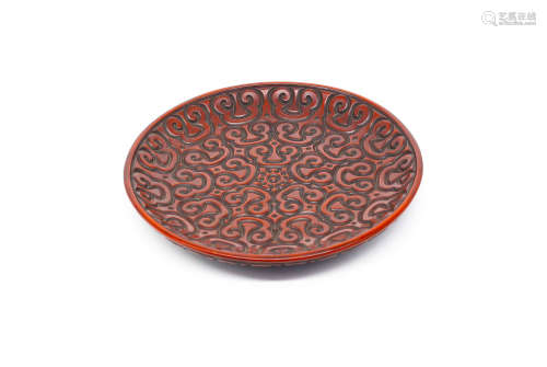 A CHINESE CARVED LACQUERWARE ROUND PLATE