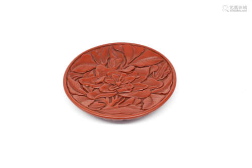 A CHINESE CARVED LACQUERWARE FLORAL PLATE