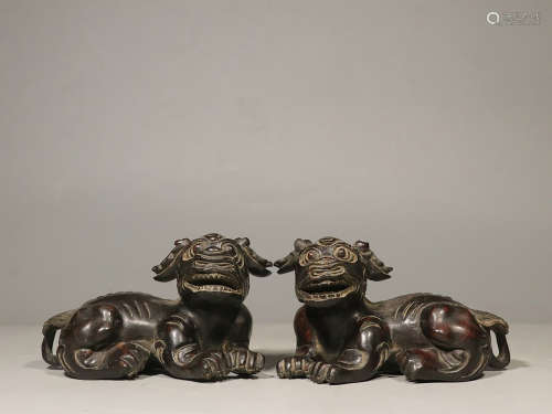 PAIR OF ZITAN WOOD CARVED RECUMBENT 'MYTHICAL BEAST' FIGURES