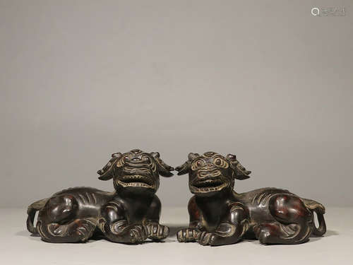 PAIR OF ZITAN WOOD CARVED RECUMBENT 'MYTHICAL BEAST' FIGURES