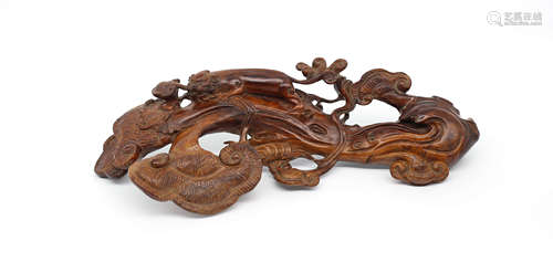 A CHINESE HUANGHUALI WOOD CARVED RUYI ORNAMENT