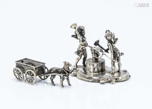 Two Edwardian silver ornaments from Berthold Muller, one modelled as two cherubs forging rings,