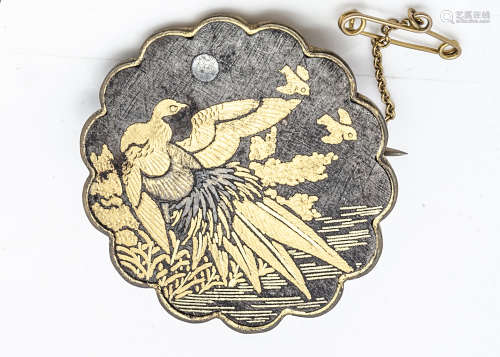 A Meiji period Japanese Amita Damascene brooch, decorated with an exotic bird with golden wings