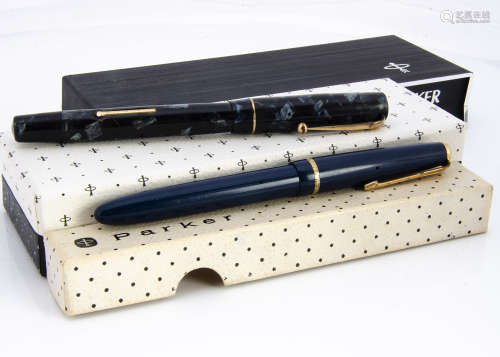 Two vintage fountain pens, a Parker Slimfold and a Swan example, with three Parker boxes